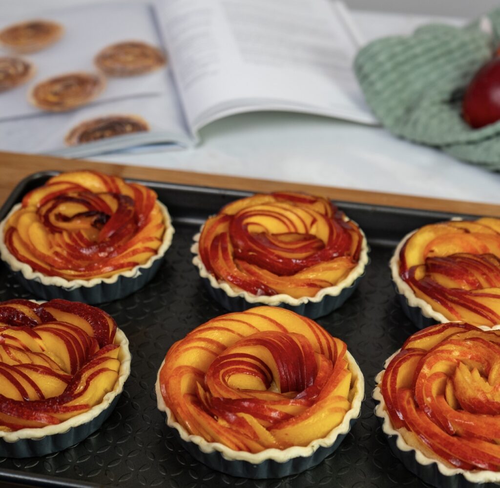 Nectarine frangipane tartlets on a baking sheet before baking