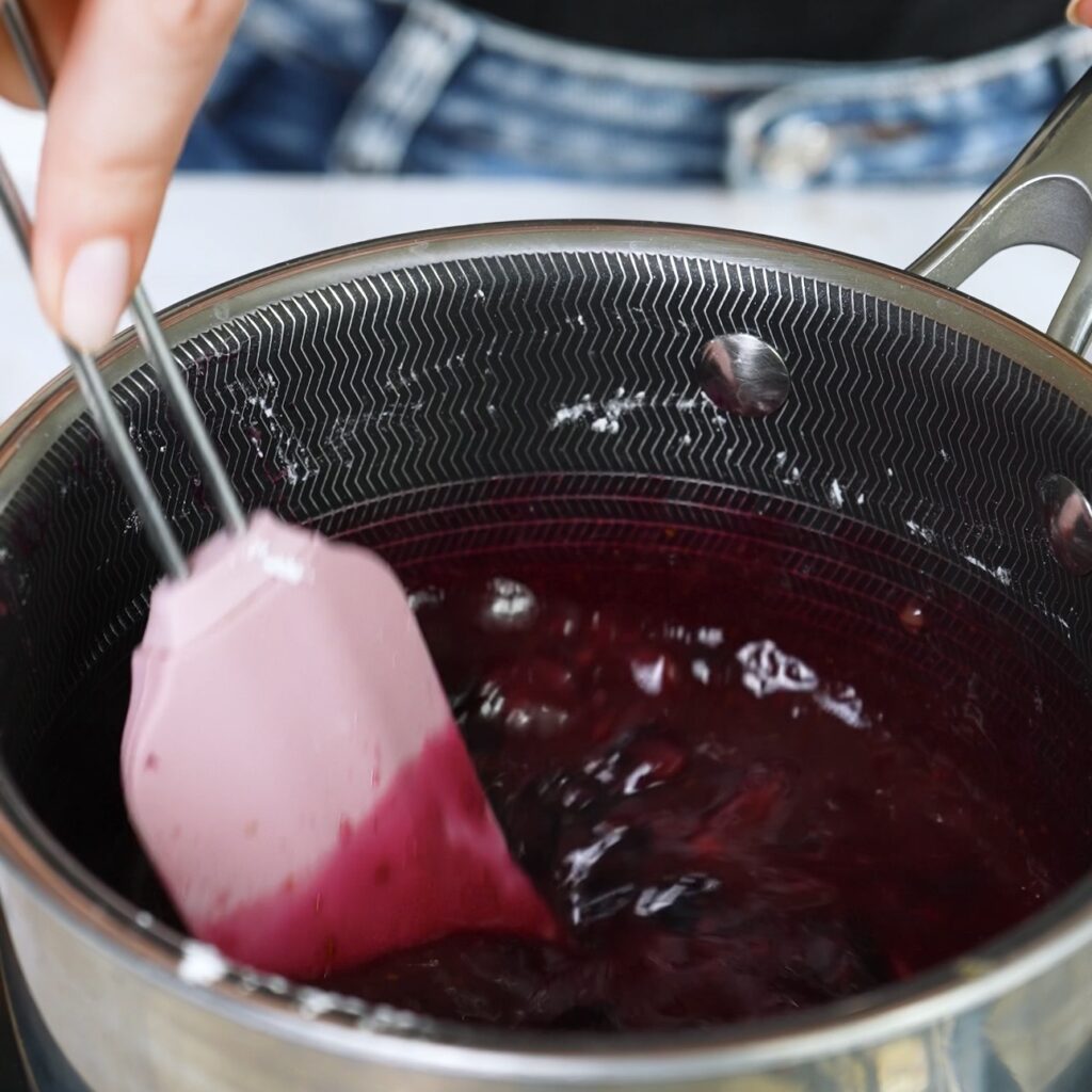 Cooking blueberry sauce in a saucepan