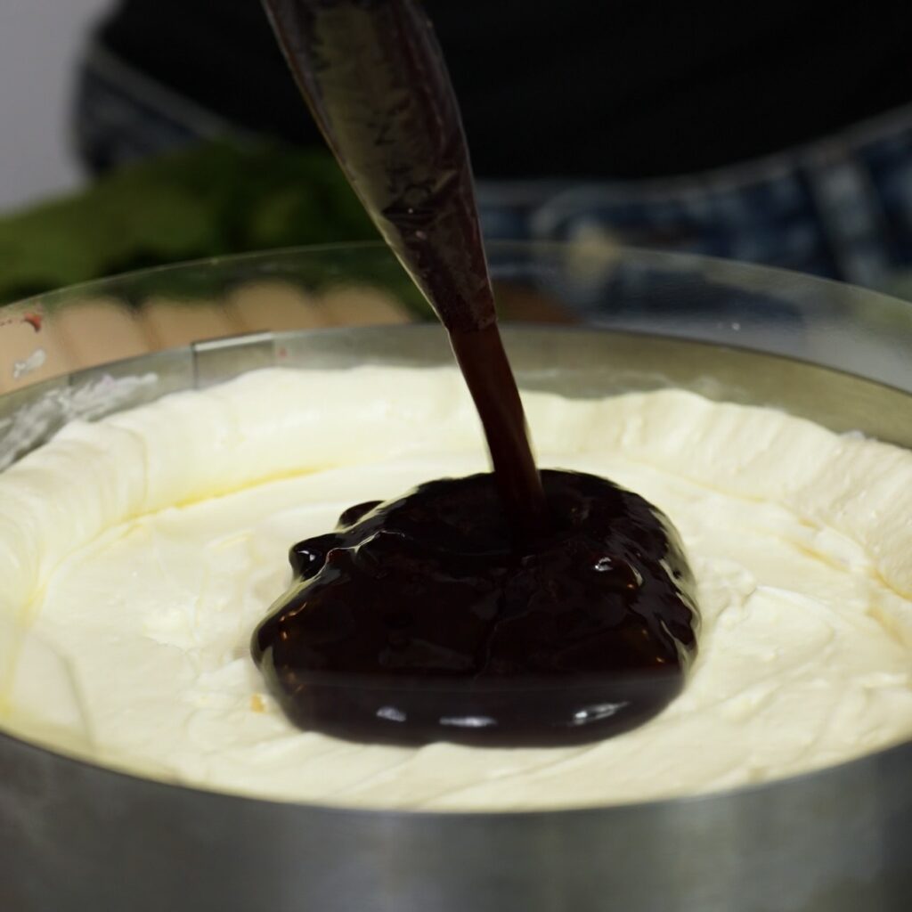 Blueberry sauce added to the centre of a piped cream rim