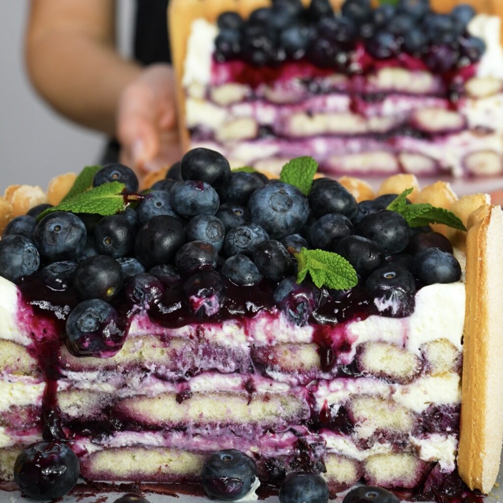 Blueberry tiramisu cake cut in half showing layered interior