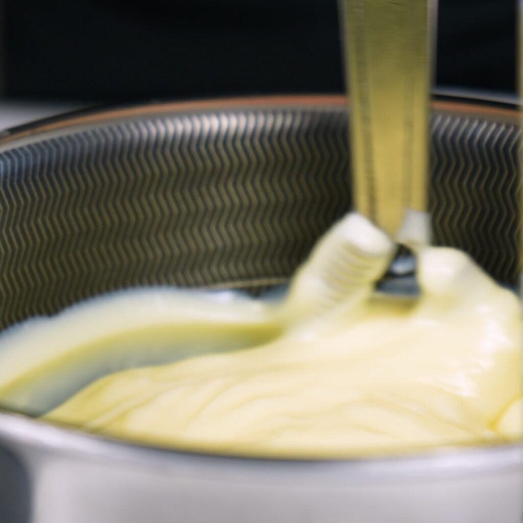 Whisking smooth vanilla custard for Baklava Cake filling