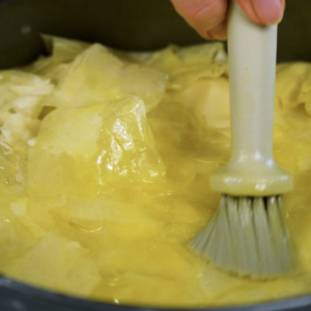 Folding and buttering the filo pastry corners over the filling
