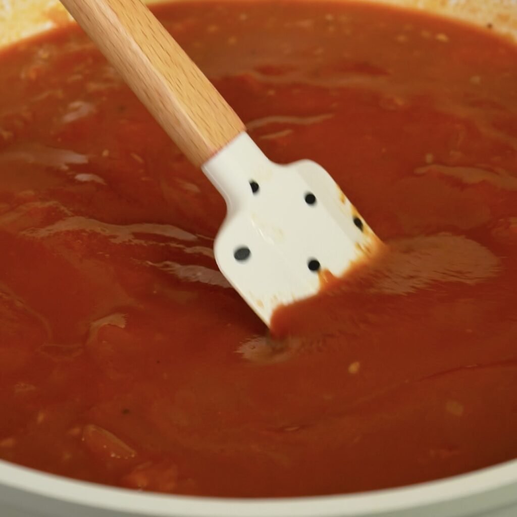 Mixing tomato sauce with passata and water