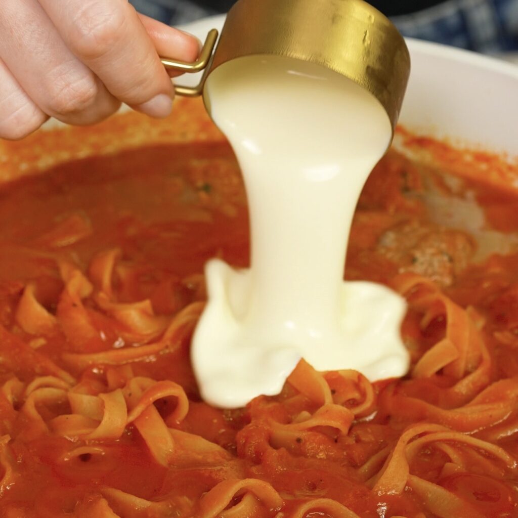Adding cream to the sauce