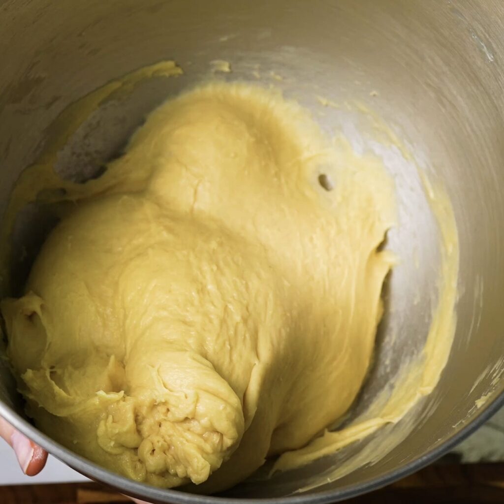 Freshly mixed smooth dough in a mixer bowl