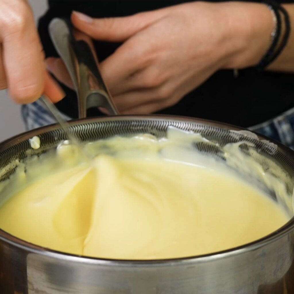 Mixing butter into warm custard