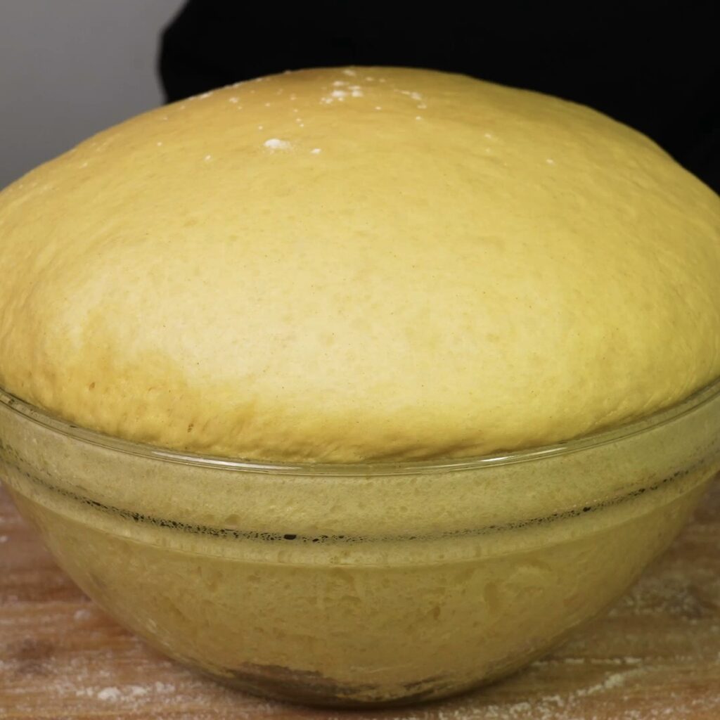 Risen dough in a bowl after proofing