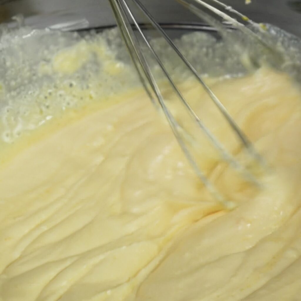 Whisking ricotta filling in a bowl.