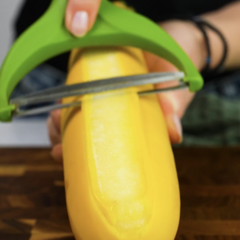 Slicing courgette and yellow squash into thin ribbons with a vegetable peeler