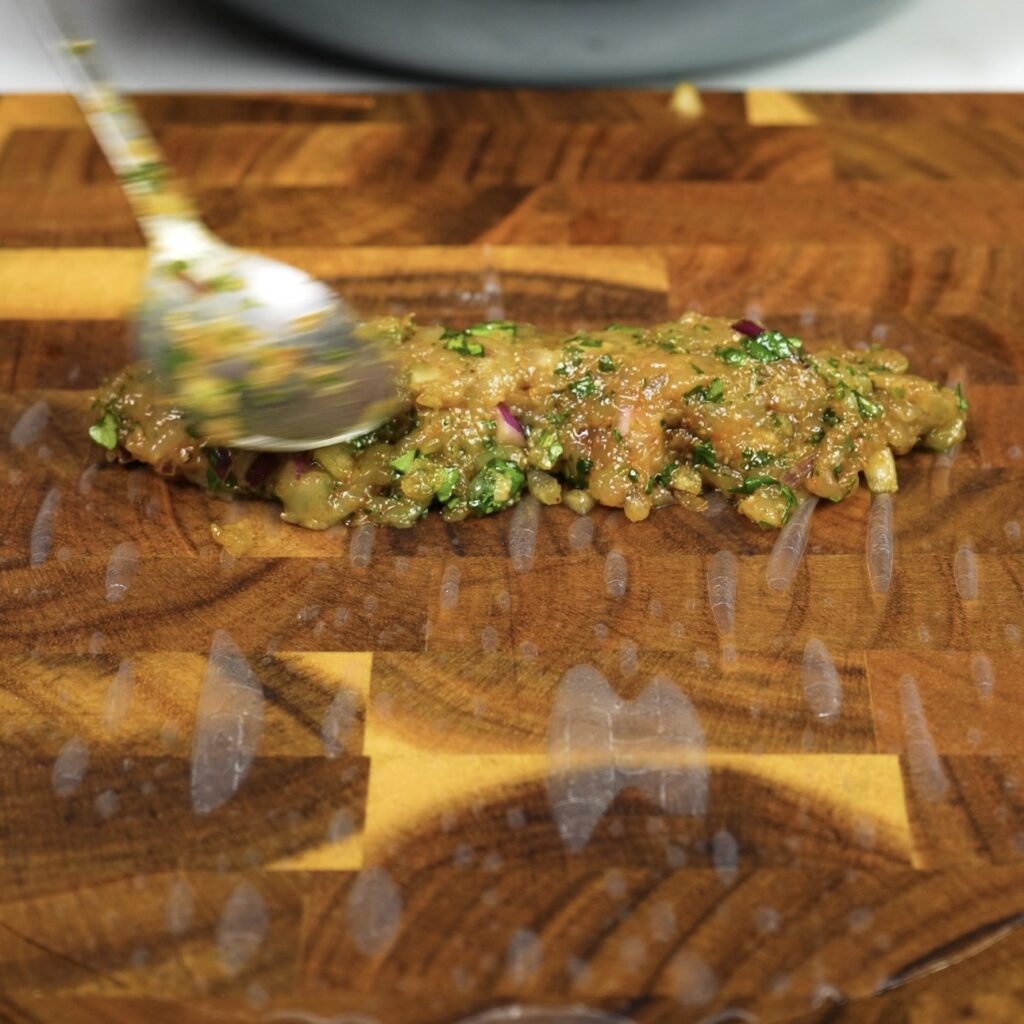 Chicken filling shaped into a log on rice paper