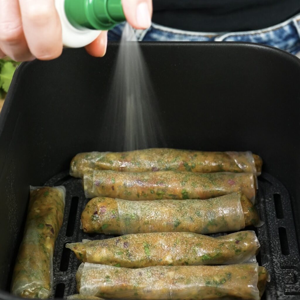 Spraying rice paper rolls in air fryer