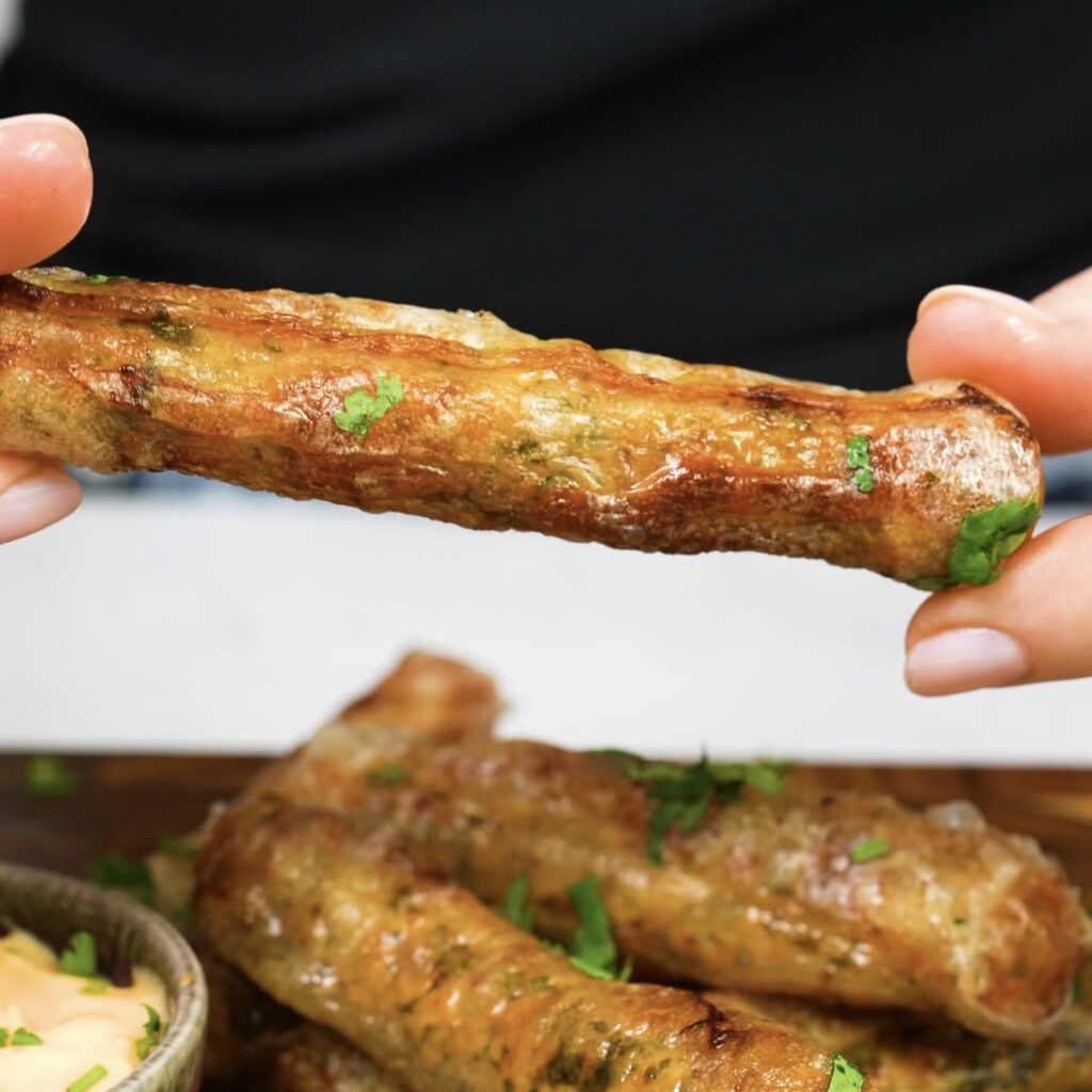 Hand holding freshly air-fried roll