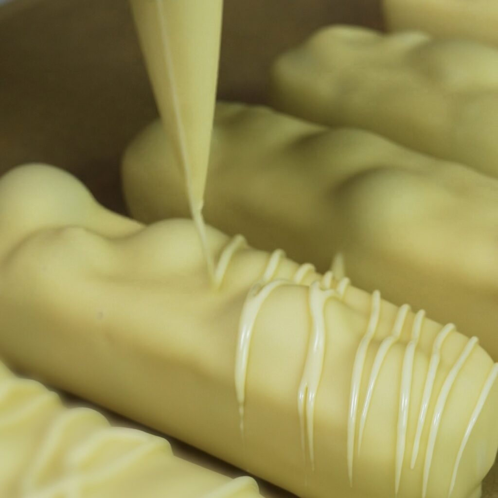 Drizzle chocolate over yogurt bars on a parchment lined tray