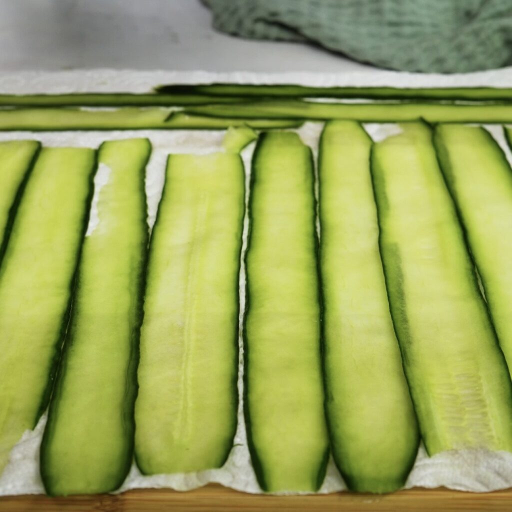 Cucumber strips laid on paper towel to dry
