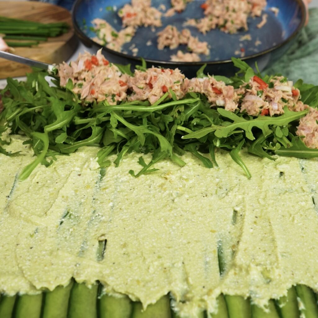 Cucumber sheet with avocado cottage cheese spread, rocket, and tuna filling