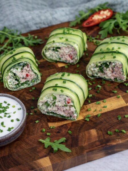 Sliced high-protein tuna cucumber roll on a wooden board