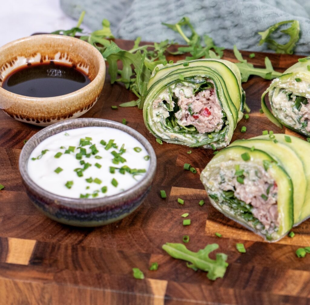 Sliced high-protein tuna cucumber roll on a wooden board
