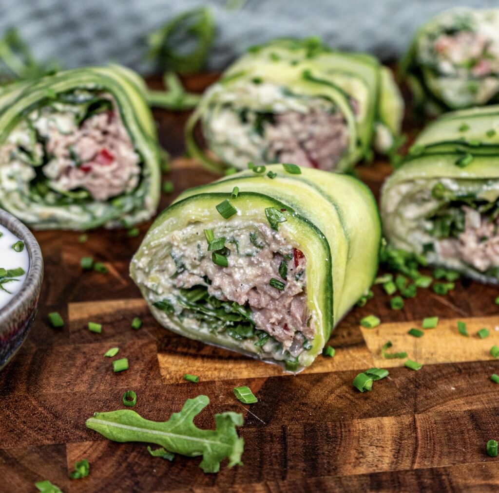Sliced high-protein tuna cucumber roll on a wooden board