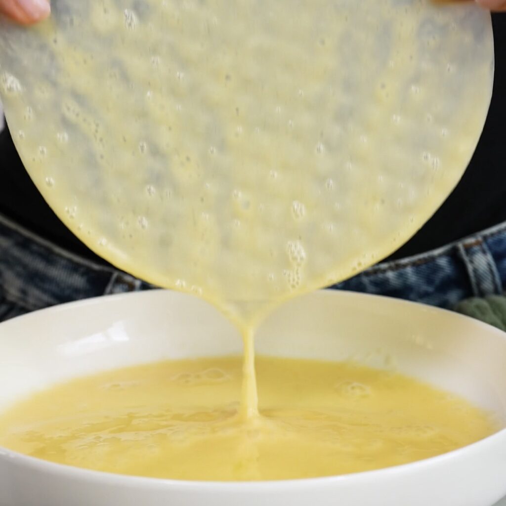 Dipping rice paper into egg and milk mixture for air fryer dessert