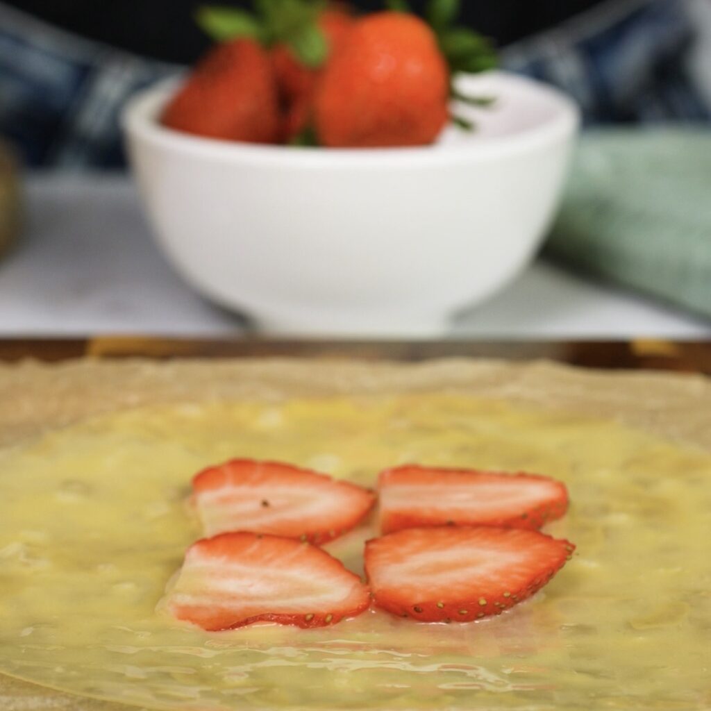 Strawberry slices arranged on rice paper for dessert parcels