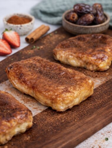 Cottage cheese strawberry rice paper dessert served on a wooden board