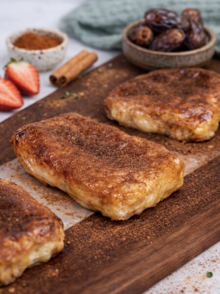 Cottage cheese strawberry rice paper dessert served on a wooden board