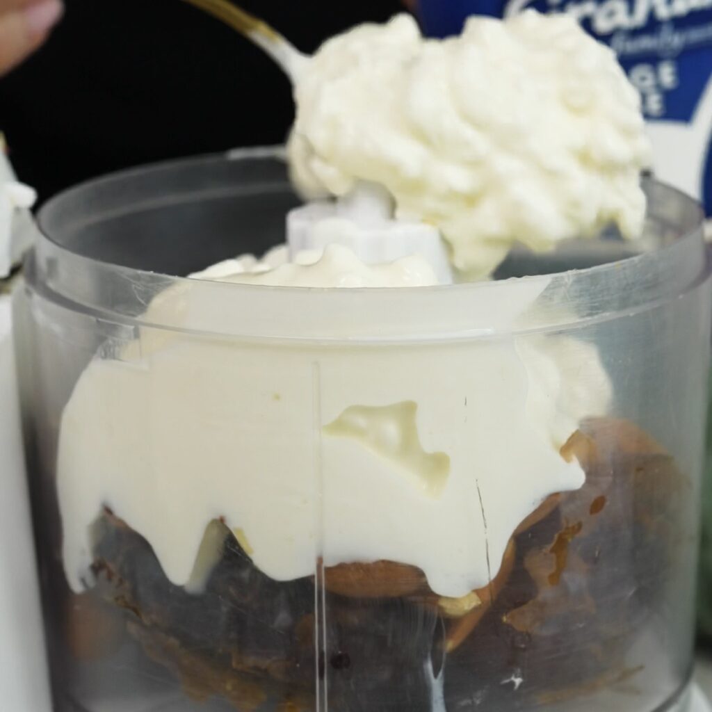 Dates, almonds and cottage cheese in a food processor ready to blend into a creamy base