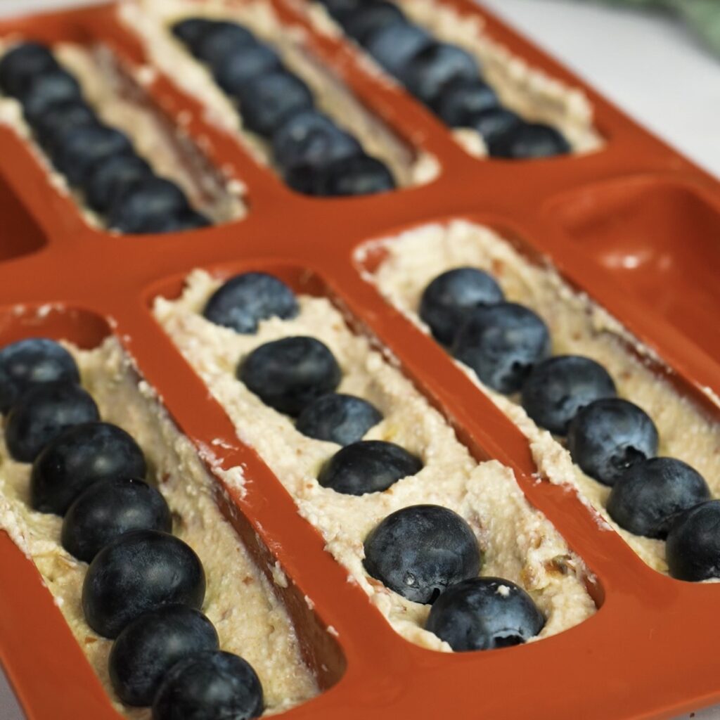 Blueberries placed in a silicone mould forming the centre of the bars