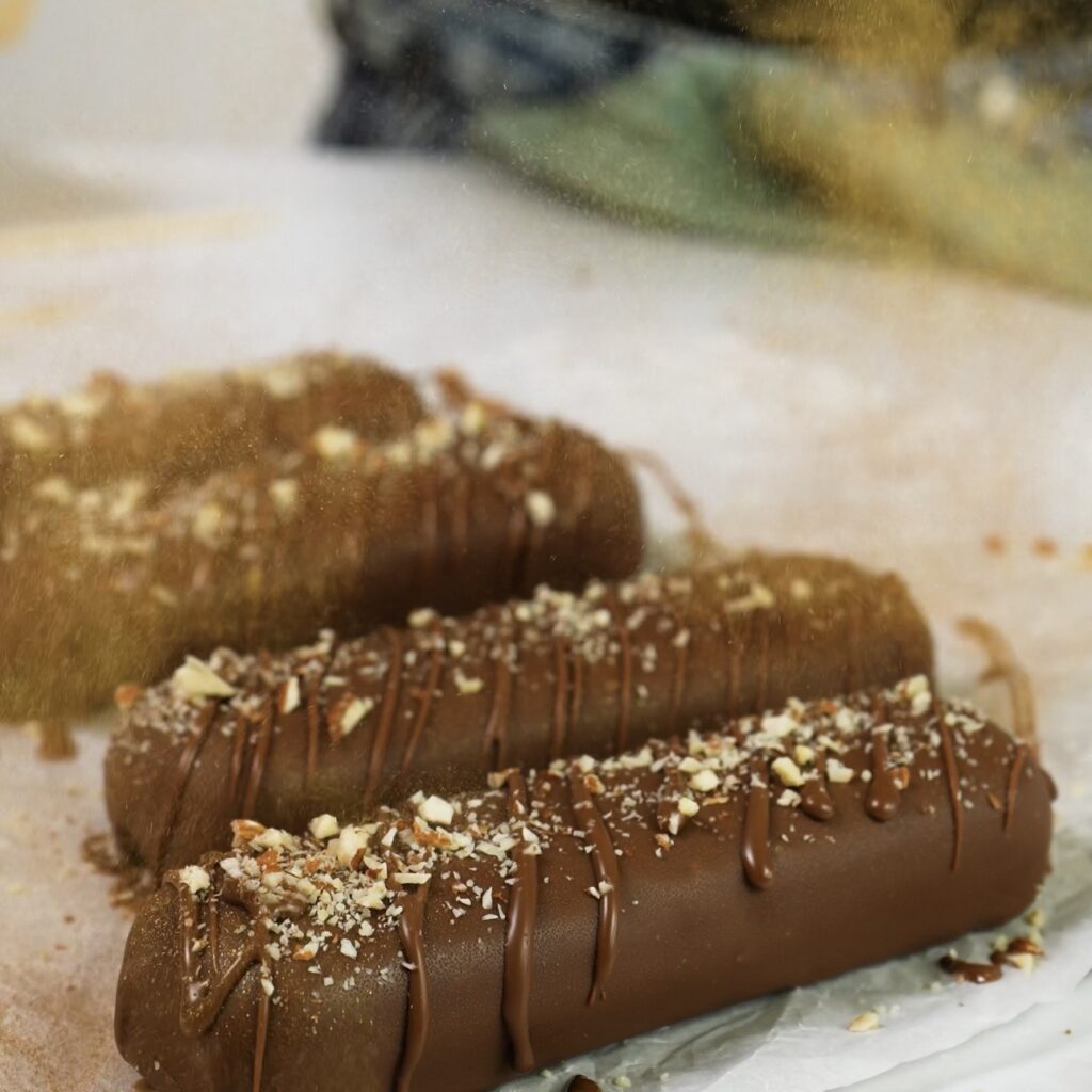Chocolate bars topped with crushed almonds and edible gold dust