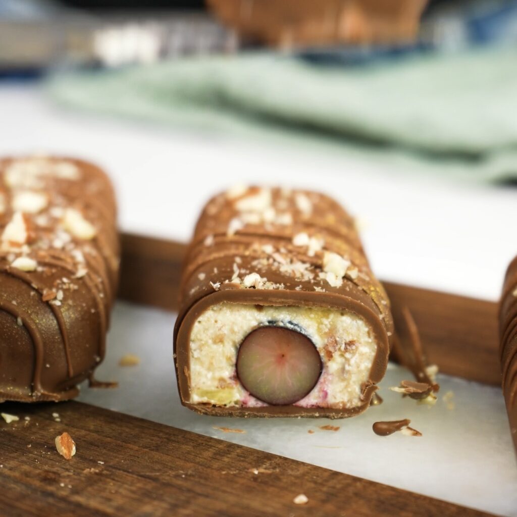 Chocolate blueberry protein bar sliced open showing creamy filling and blueberry centre