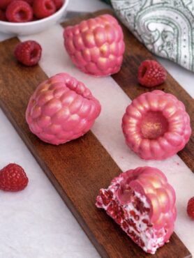 Chocolate raspberry yogurt gems served on a wooden board