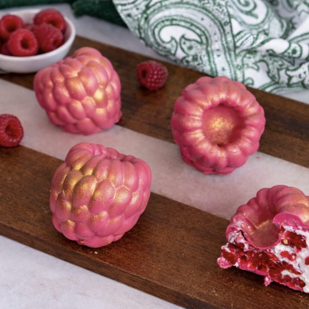 Chocolate raspberry yogurt gems served on a wooden board