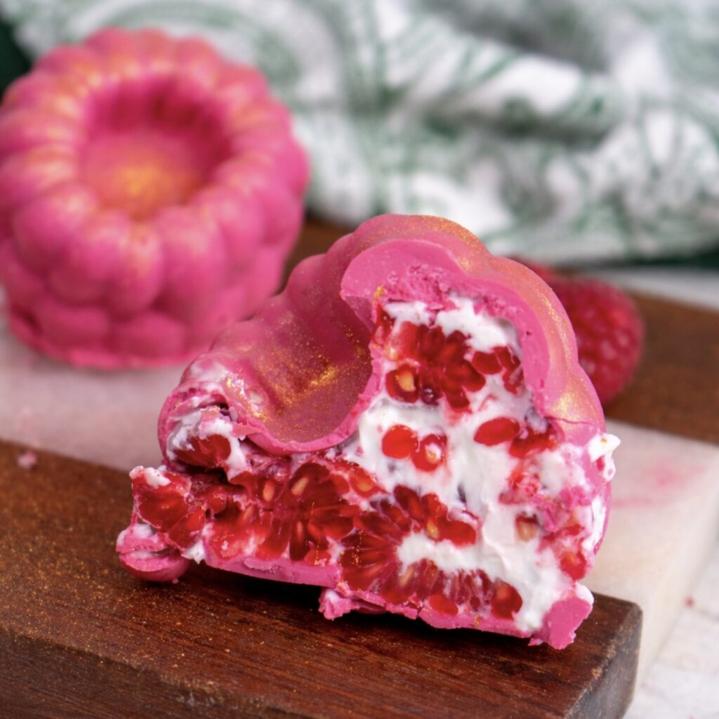 Chocolate raspberry yogurt gem sliced in half showing the filling