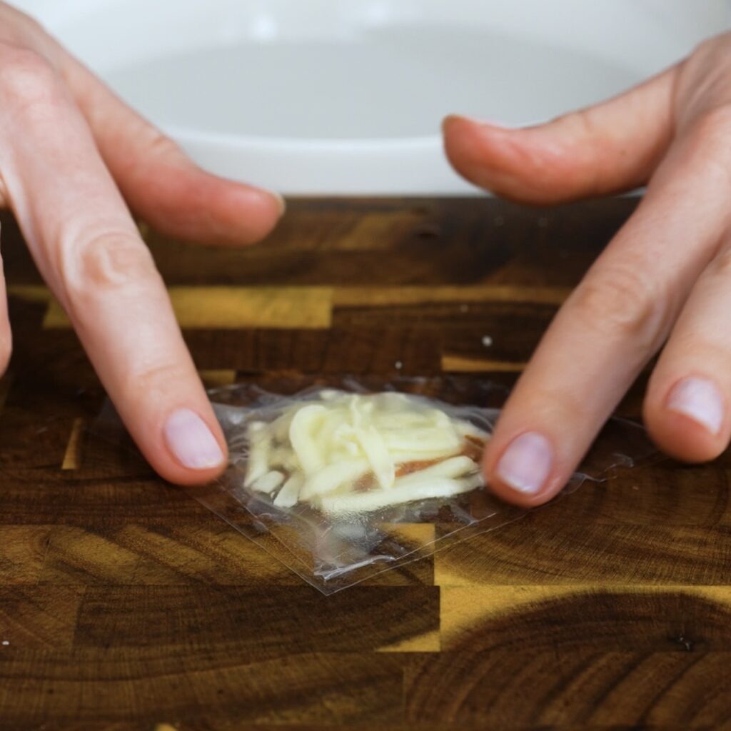 Rice paper filled with mozzarella and sun-dried tomato pesto, covered and sealed