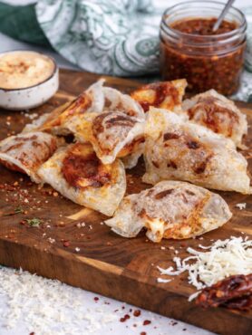 Crispy rice paper mozzarella chips served on a wooden board