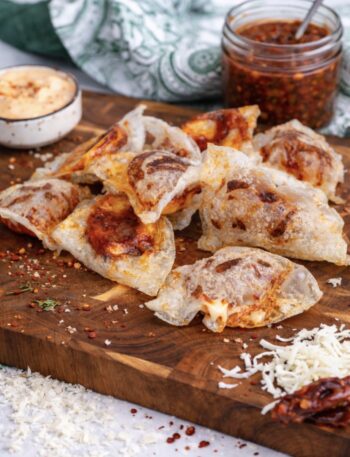 Crispy rice paper mozzarella chips served on a wooden board