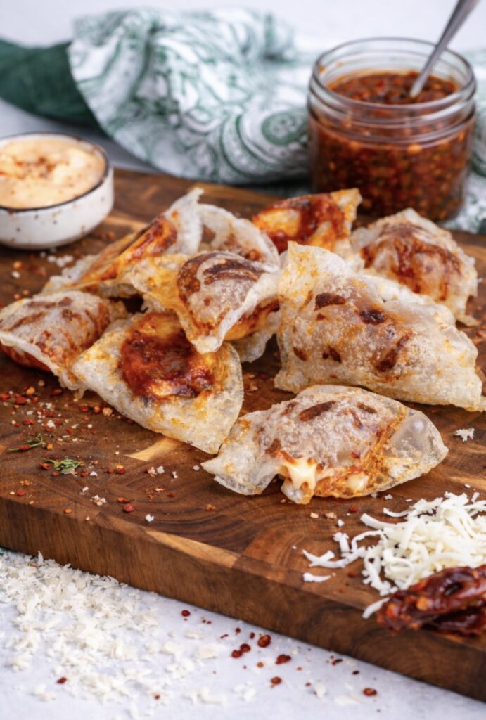 Crispy rice paper mozzarella chips served on a wooden board