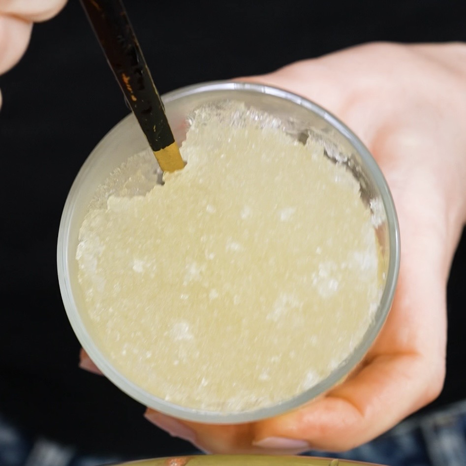 Bloomed gelatine in a glass ready for strawberry fluff squares