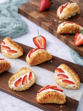 Strawberry cream cheese shells served on a wooden board
