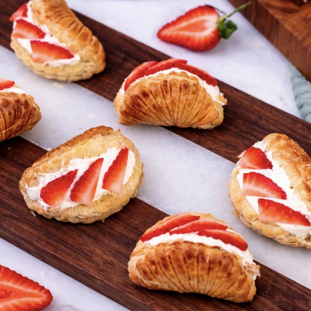 Strawberry cream cheese shells served on a wooden board