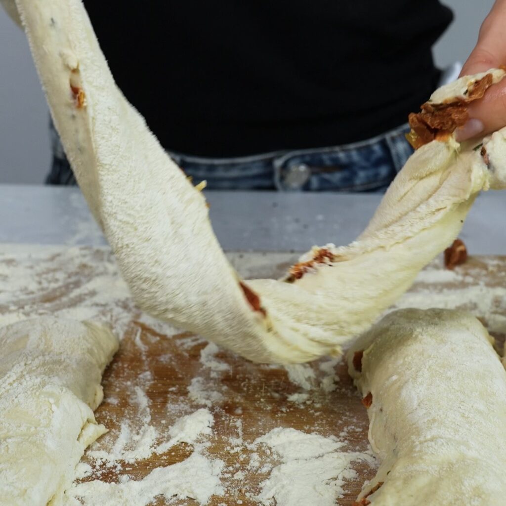 Twisting soft no-knead dough into rustic bread twists