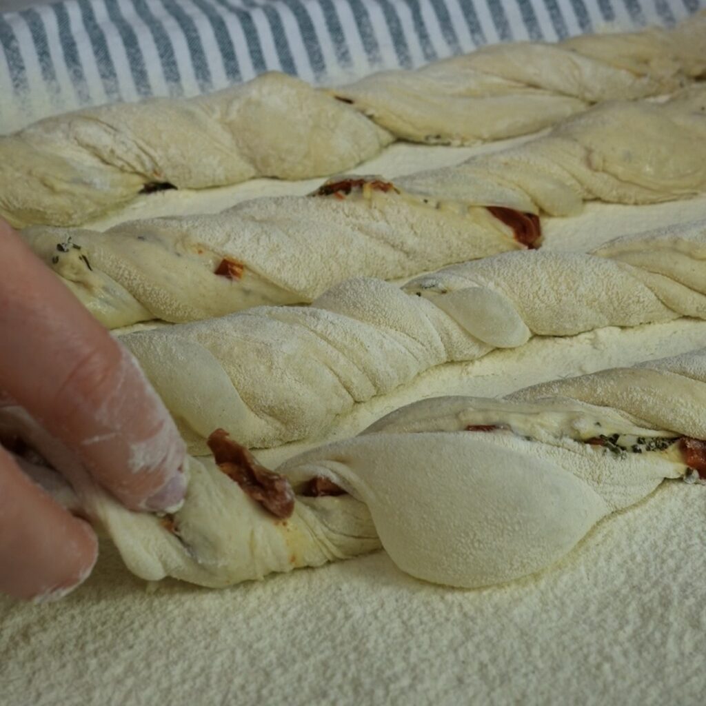 Placing twisted dough onto floured towel for final proof