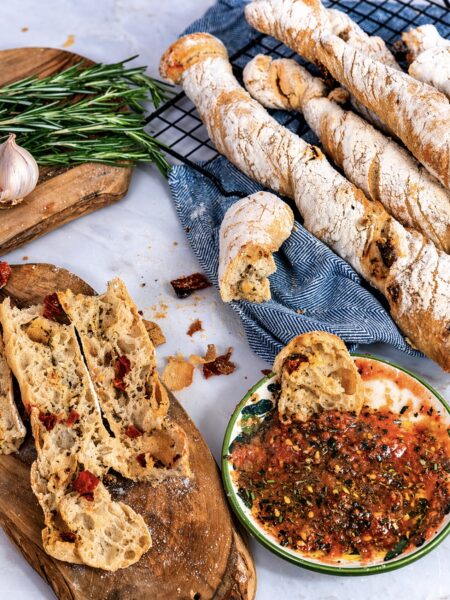 Baked sun-dried tomato rosemary bread twists served with dipping oil