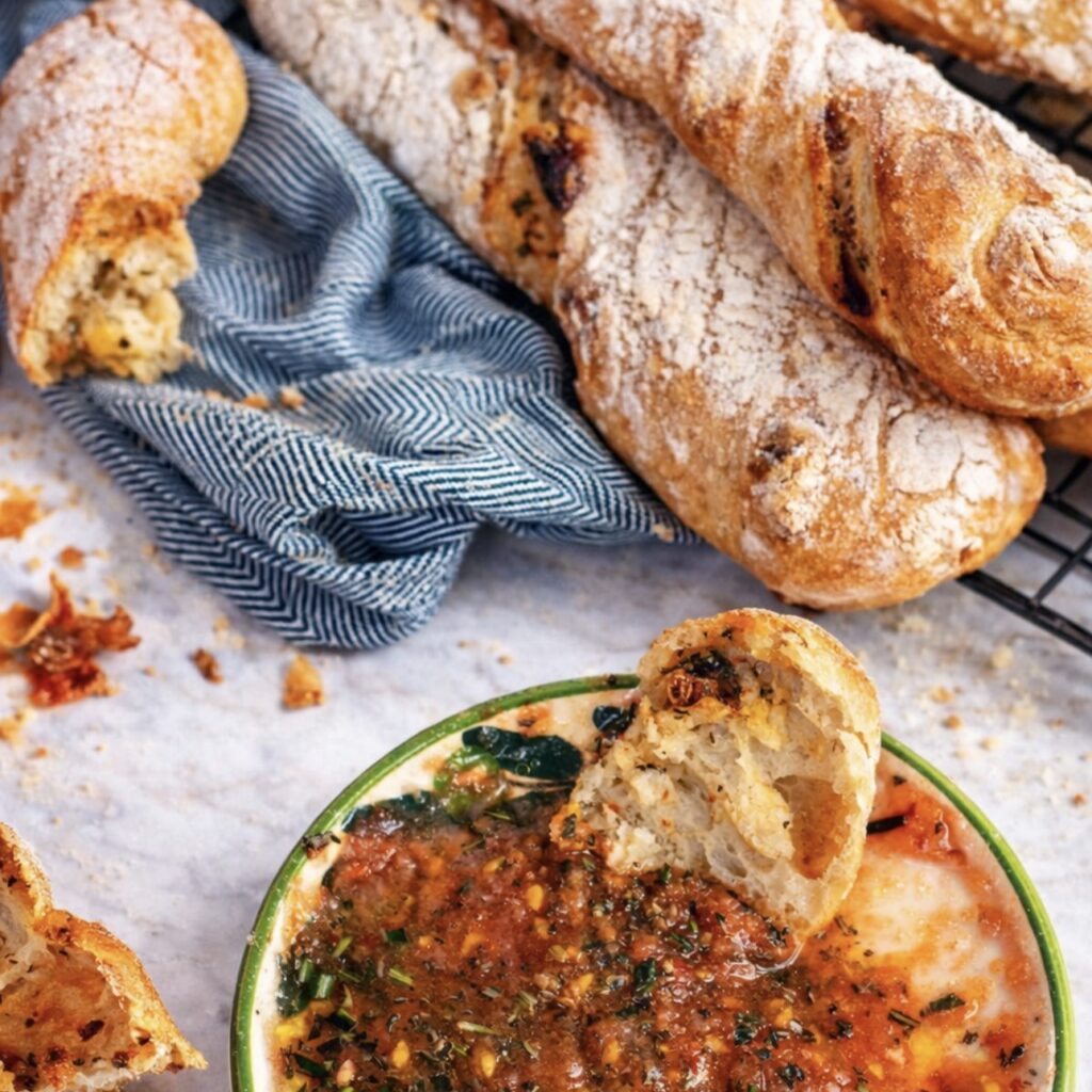 Baked sun-dried tomato rosemary bread twists served with dipping oil