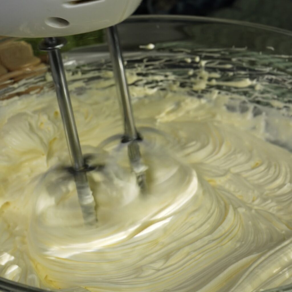 Whisking mascarpone cream until smooth and thick