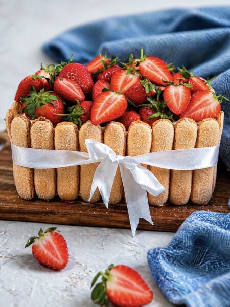 Finished strawberry tiramisu cake served on a wooden board
