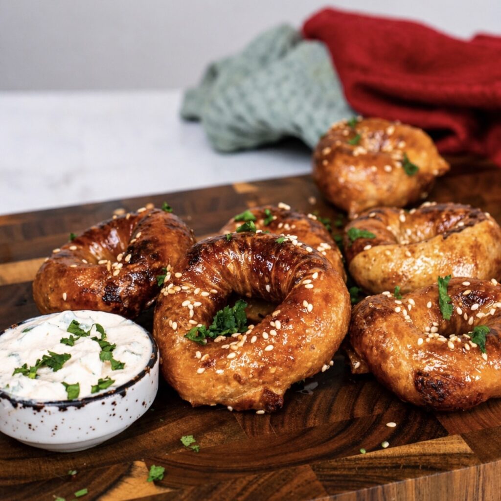 Air Fryer Pesto Parmesan Rice Paper Rings served on a wooden board with dipping sauce