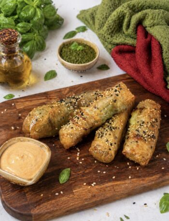 Air Fryer Pesto Mozzarella Rice Paper Sticks served on a wooden board