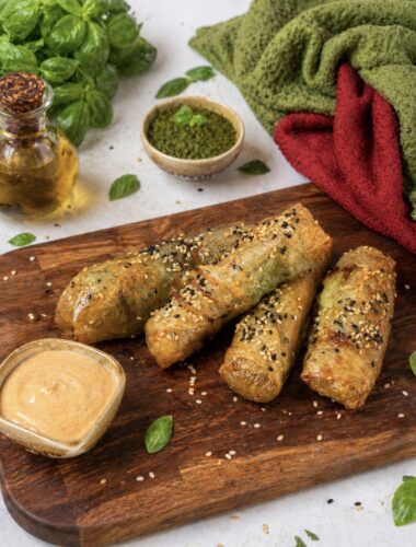 Air Fryer Pesto Mozzarella Rice Paper Sticks served on a wooden board