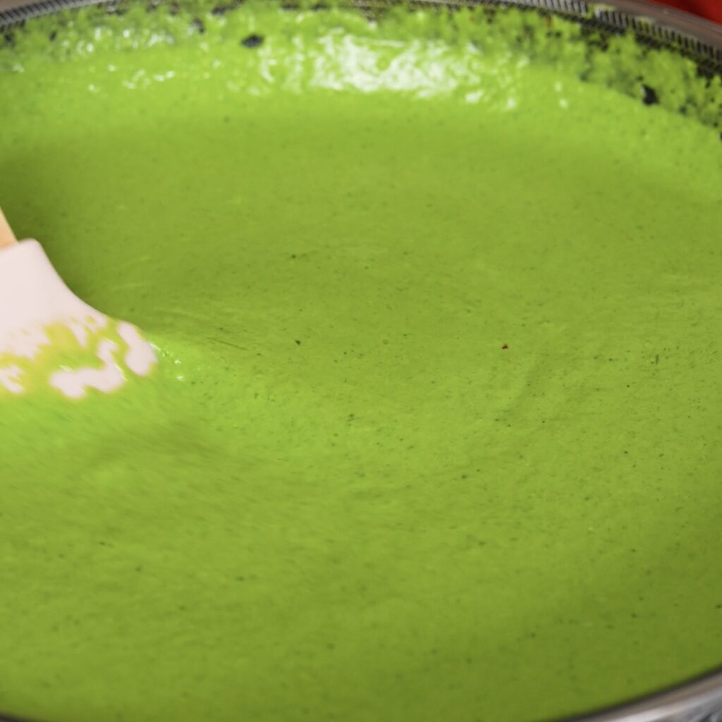 Spinach ricotta sauce simmering in a pan before adding pasta